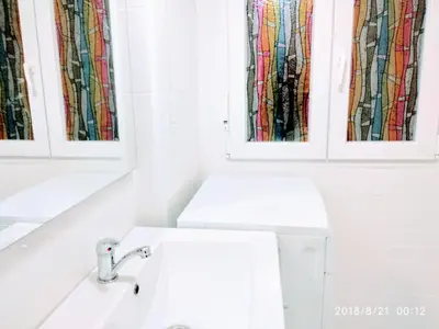 a bathroom with a sink and a mirror at Valencian Dreams of the Proletariat in Valencia