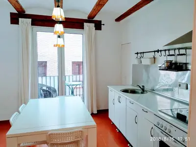 a kitchen with white cabinets and a large window at Valencian Dreams of the Proletariat in Valencia