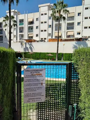 a man jumping into a swimming pool with a basketball at Habitación doble con baño privado, Desayuno y piscina in Alboraya
