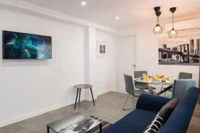 a living room with a blue couch and a table at Invalencia - Marques Flat Cabanyal Apartment in Valencia