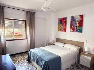 a bedroom with a bed and a window at Apartamento Careme in Tavernes de Valldigna