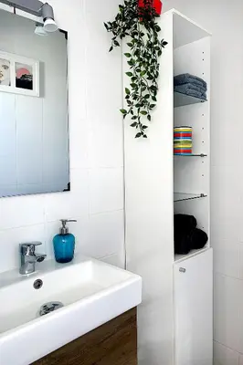 a bathroom with a white sink and a mirror at Apartamento Careme in Tavernes de Valldigna