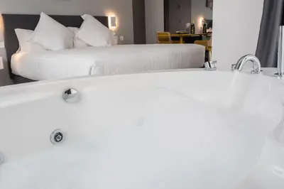 two beds in a room with two white beds at Sercotel Valencia Alameda 41 in Valencia