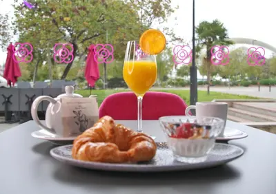 a table with a plate of food and a glass of orange juice at Sercotel Valencia Alameda 41 in Valencia