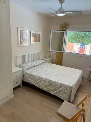 a bedroom with a bed and a window at Apartamento de lujo en Canet de Berenguer a 150 m de la playa in Canet de Berenguer