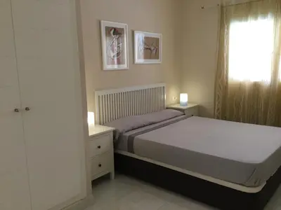 a bedroom with a large bed and a window at Apartamento de lujo en Canet de Berenguer a 150 m de la playa in Canet de Berenguer