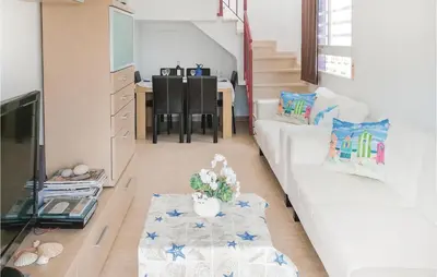a living room with a white couch and a table at Cozy Apartment In Moncófar With Wifi in Moncófar