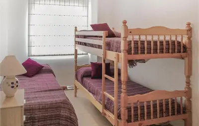 a bedroom with two bunk beds and a lamp at Cozy Apartment In Moncófar With Wifi in Moncófar