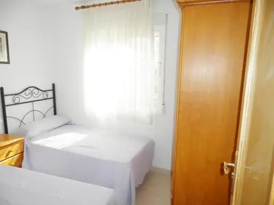a bedroom with two beds and a window at Apartamentos rurales Benafer in Benafer
