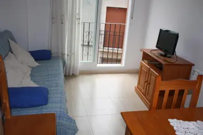 a small living room with a tv and a couch at Apartamentos rurales Benafer in Benafer