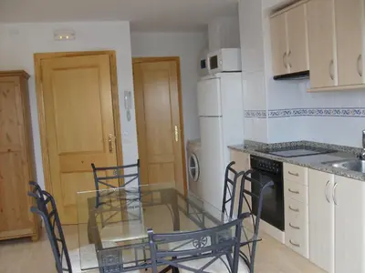 a kitchen with a glass table and chairs in it at Apartamentos rurales Benafer in Benafer