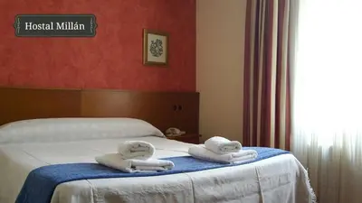 two towels on a bed in a hotel room at Hostal Millán in Segorbe