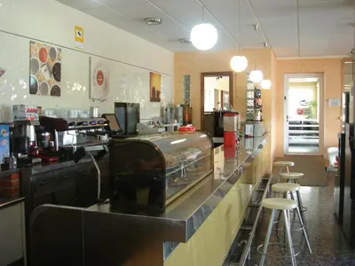 a restaurant kitchen with a counter and stools at Hostal Millán in Segorbe