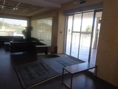 a living room with a table and a large rug at Hostal Millán in Segorbe