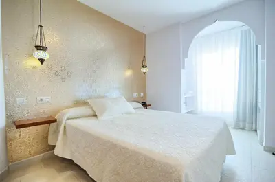 a bedroom with a bed and a large window at Hotel Boutique Sabbia Valencia in Valencia