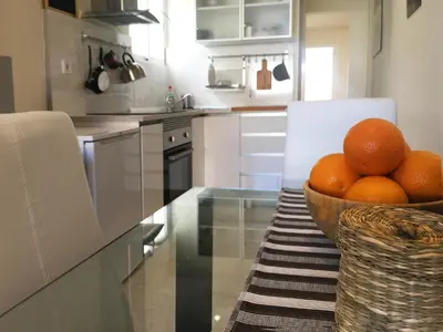 a bowl of oranges sitting on a table in a kitchen at Ático cerca del mar in Valencia