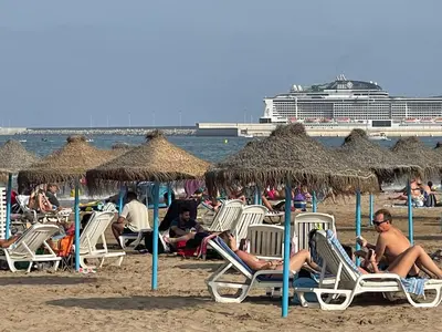 a group of people sitting in chairs on the beach at Preciosa Casita Cerca Del Mar in Valencia