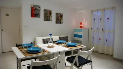 a kitchen with a table with blue dishes on it at Apartamento Portalet 7 in Benaguacil