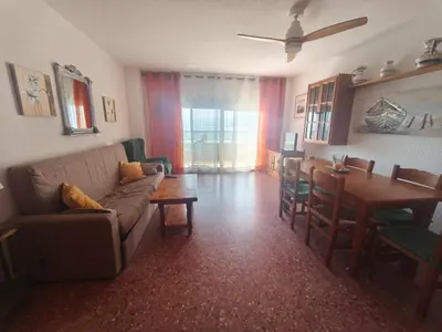 a living room with a couch and a table at Apartamento Florazar 2, 8ºC in Cullera