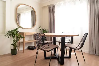 a dining room with a table and chairs and a mirror at TTdSSa VLC Plaza Cisneros in Valencia