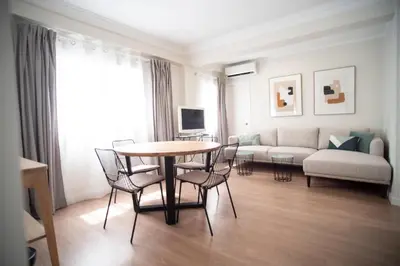 a living room with a table and chairs and a couch at TTdSSa VLC Plaza Cisneros in Valencia