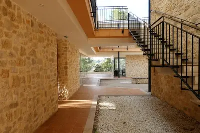 an open hallway with stairs and a stone wall at Hotel de Montaña La Rocha in Quesa