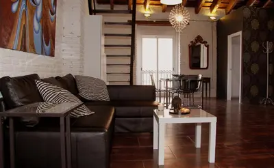 a living room with a couch and a table at Penthouse in historic center in Valencia