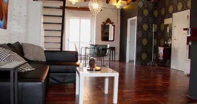 a living room with a couch and a table at Penthouse in historic center in Valencia