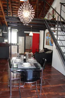 a dining room with a table with chairs and a chandelier at Penthouse in historic center in Valencia