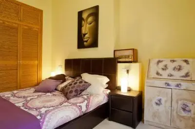 a bedroom with a bed with a head on the wall at Apartament in historic center in Valencia