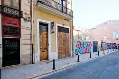 a street with some graffiti on the side of a building at Apartament in historic center in Valencia