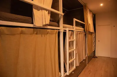 a room with two bunk beds and a hallway at Cantagua Hostel in Valencia
