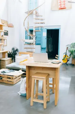 a wooden table with a laptop on top of it at Cantagua Hostel in Valencia