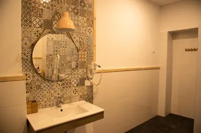 a bathroom with a sink and a mirror at Cantagua Hostel in Valencia