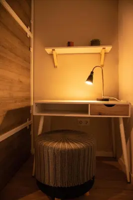 a desk with a lamp and a stool in a room at Cantagua Hostel in Valencia