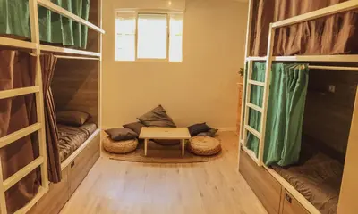 a room with a table and two bunk beds at Cantagua Hostel in Valencia