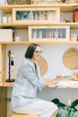 a woman sitting on a shelf with a book at Cantagua Hostel in Valencia