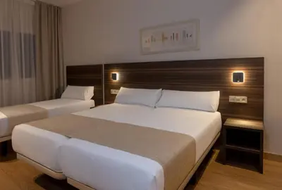 a hotel room with two beds in a room at Hotel Belcaire in Vall de Uixó