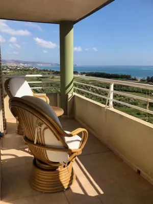 two chairs on a balcony with a view of the ocean at Retiro Playa y Spa in Tavernes de Valldigna