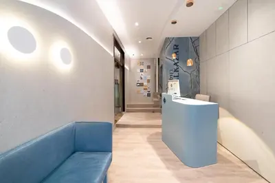 a hallway with a blue bench in a building at Hotel Alkazar in Valencia