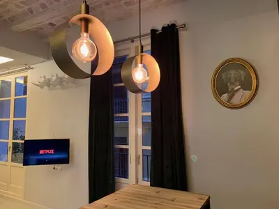 a dining room with a table and a clock on the wall at Mediterranean Flats Plaza Redonda in Valencia