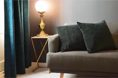 a lamp on a table next to a couch with pillows at Mediterranean Flats Plaza Redonda in Valencia