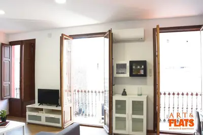 a living room with a mirror and a tv at Calle Cuenca in Valencia