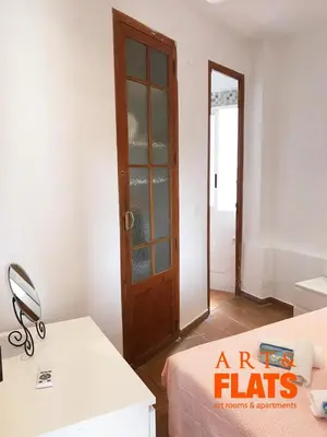 a room with a door and a table and a bed at CALLE CUENCA 2 in Valencia
