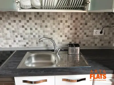 a stainless steel sink in a kitchen with tiles at CALLE CUENCA 2 in Valencia