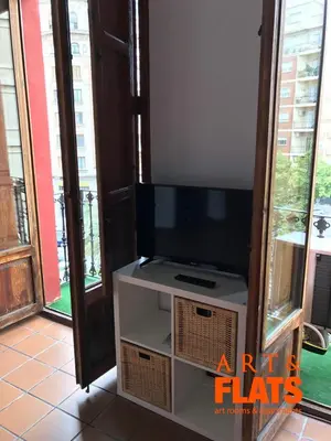 a flat screen tv sitting on top of a cabinet at CALLE CUENCA 2 in Valencia