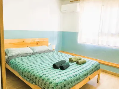 a bedroom with a bed with two pillows on it at Casa Maritim Cabanyal in Valencia