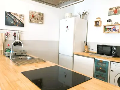 a kitchen with a sink and a refrigerator at Casa Maritim Cabanyal in Valencia
