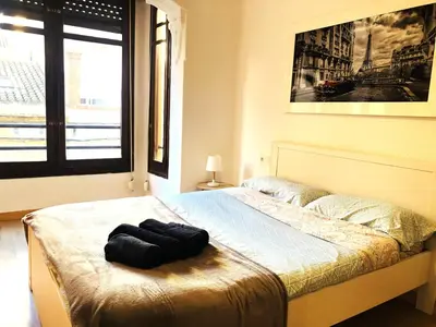 a bedroom with a bed with a black object on it at Casa Maritim Cabanyal in Valencia