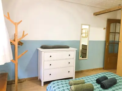 a bedroom with a bed and a dresser and a mirror at Casa Maritim Cabanyal in Valencia